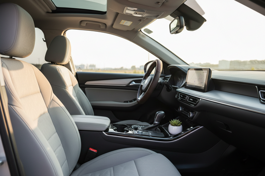 Modern car interior with fitted seat covers, clean dashboard, steering wheel cover, soft natural lighting, and a comfortable everyday driving mood. Realistic ecommerce blog thumbnail, no people, no text, no logo.